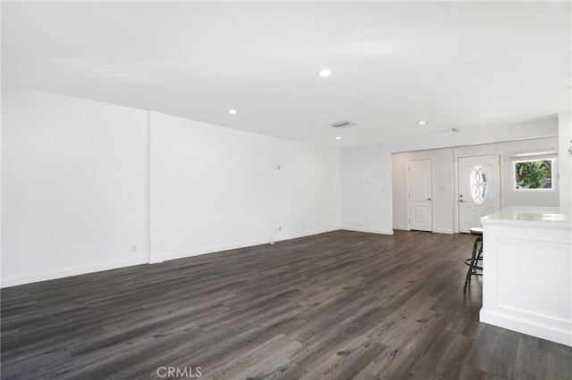 unfurnished living room with dark hardwood / wood-style flooring