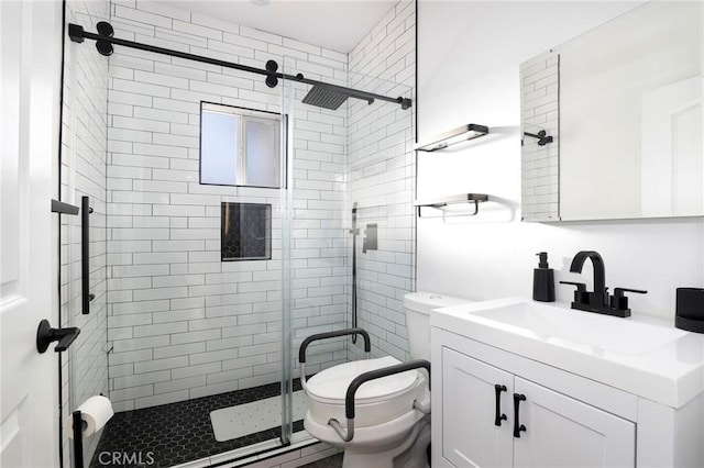 bathroom with vanity, an enclosed shower, and toilet