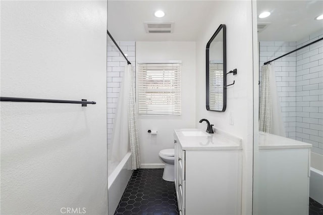 full bathroom featuring tile patterned flooring, vanity, toilet, and shower / bath combo