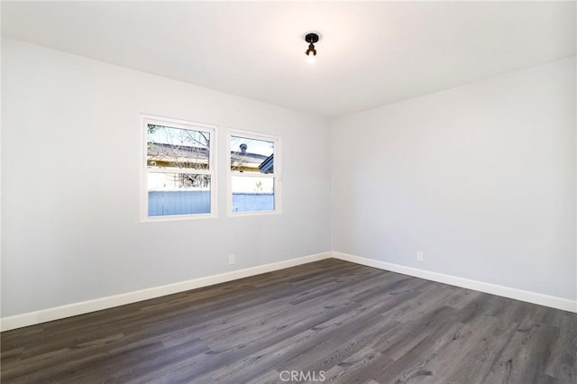 empty room featuring dark hardwood / wood-style flooring