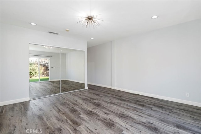 unfurnished bedroom with dark hardwood / wood-style floors and a closet