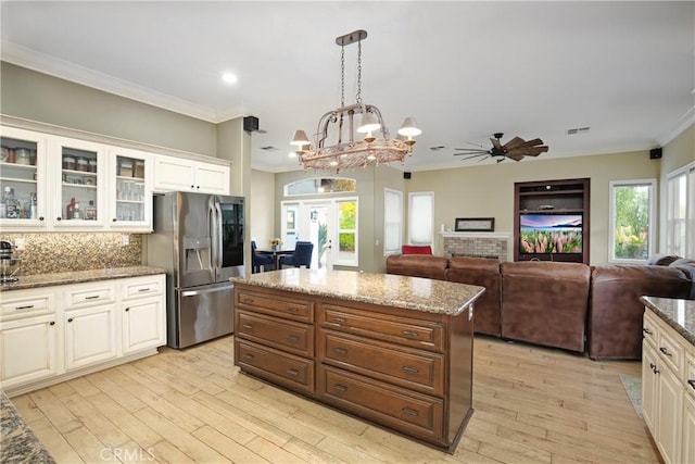 16082 Citrus Grove Ct, Riverside, CA 92504 - kitchen with stainless steel refrigerator with ice dispenser, ornamental molding, light wood-style floors, and french doors