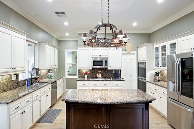 16082 Citrus Grove Ct, Riverside, CA 92504 - kitchen featuring a sink, light wood finished floors, decorative backsplash, and stainless steel appliances