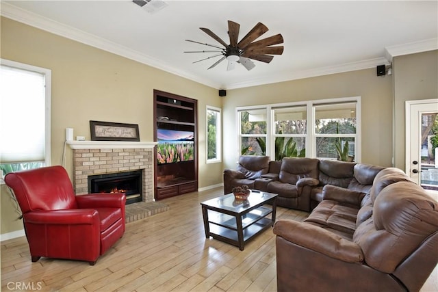 16082 Citrus Grove Ct, Riverside, CA 92504 - living area featuring crown molding, light wood-style floors, a brick fireplace, a ceiling fan, and baseboards
