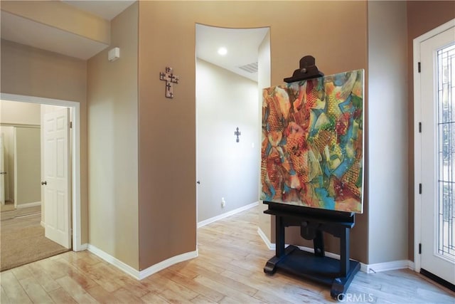 corridor with light hardwood / wood-style flooring