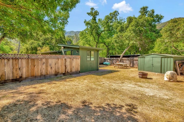 view of yard with a mountain view and a shed