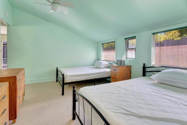 bedroom featuring vaulted ceiling, light colored carpet, and ceiling fan