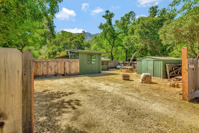 view of yard with a storage unit and a mountain view