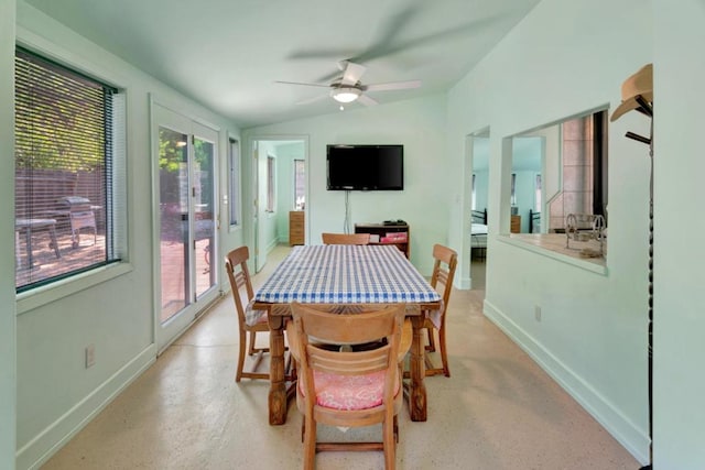 dining space with ceiling fan and vaulted ceiling