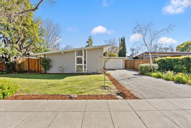 view of front of home with a garage and a front yard