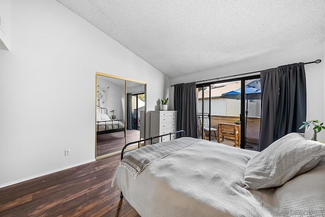 bedroom featuring lofted ceiling, dark wood-type flooring, a closet, and a textured ceiling