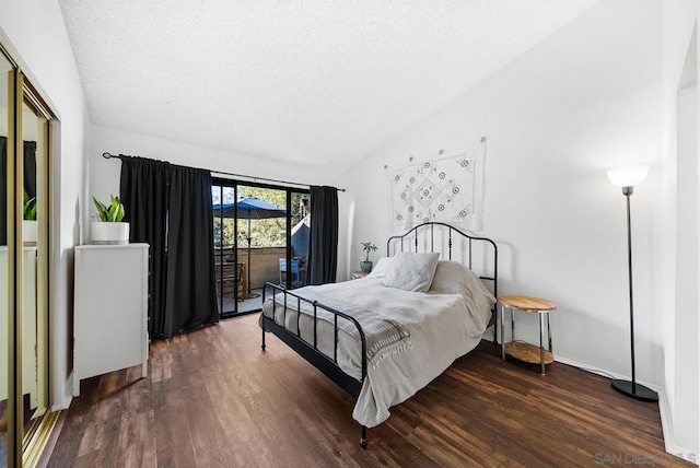 bedroom with lofted ceiling, access to outside, a textured ceiling, and dark hardwood / wood-style flooring