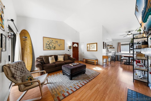 living room featuring hardwood / wood-style flooring, high vaulted ceiling, and ceiling fan