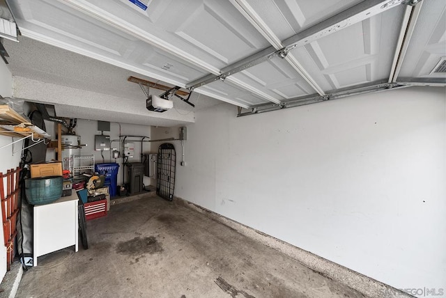 garage with a garage door opener and electric panel