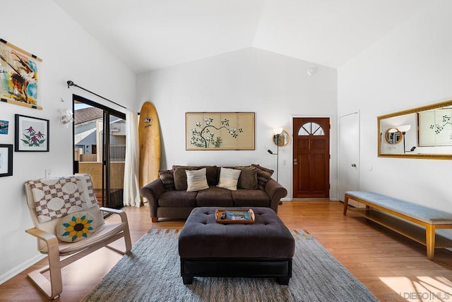 living room with hardwood / wood-style flooring and high vaulted ceiling