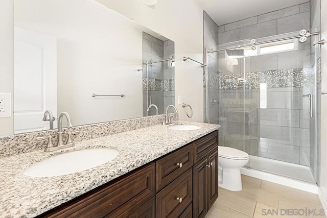 bathroom featuring vanity, toilet, and walk in shower