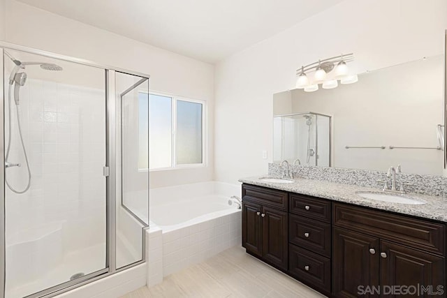 bathroom featuring vanity and shower with separate bathtub