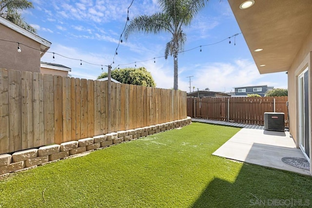 view of yard with cooling unit and a patio area