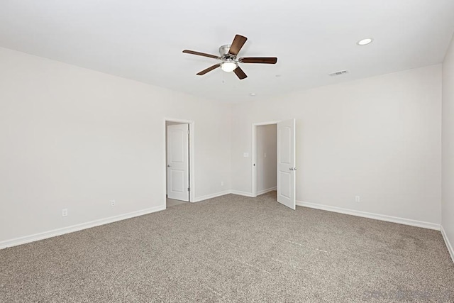 unfurnished room with ceiling fan and carpet