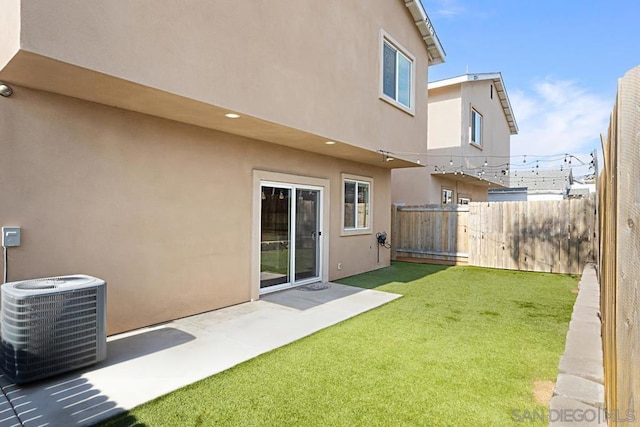 view of yard featuring a patio area and central air condition unit