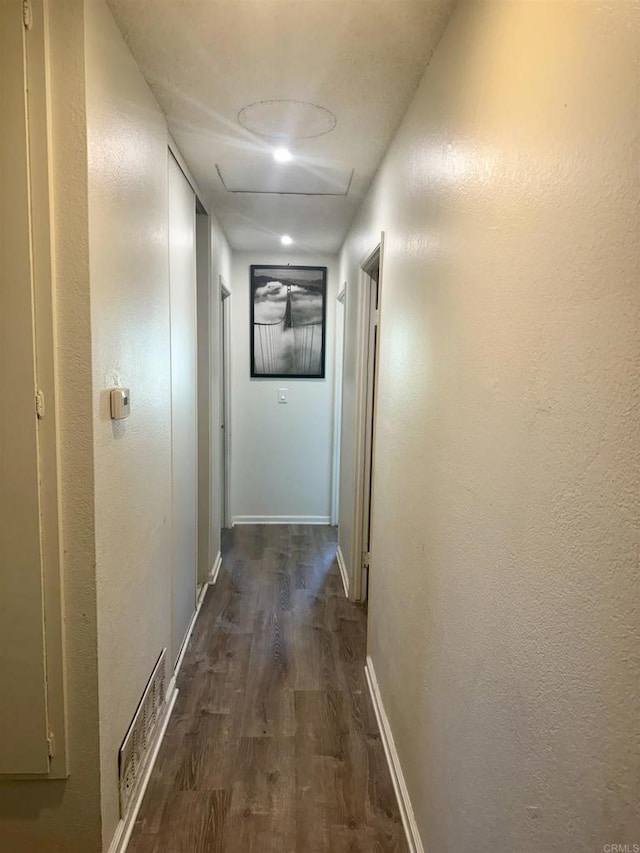 hallway with dark hardwood / wood-style floors