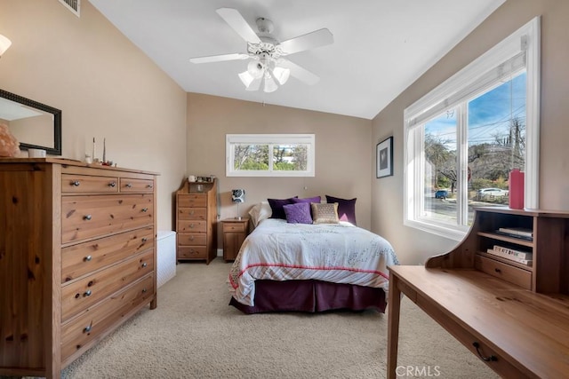 bedroom featuring ceiling fan, vaulted ceiling, and light carpet