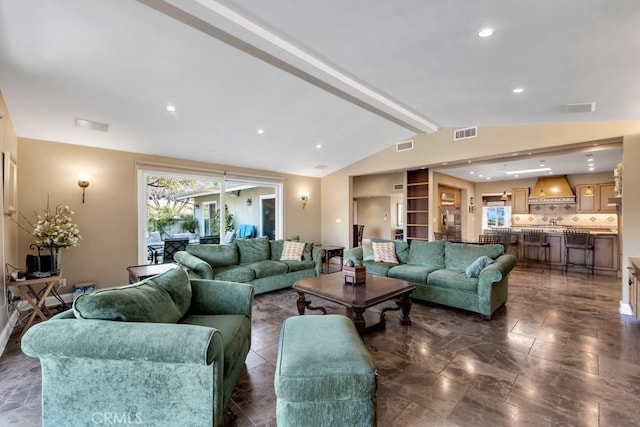 living room with lofted ceiling with beams