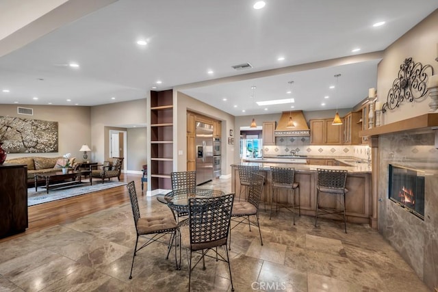 dining area featuring a tiled fireplace