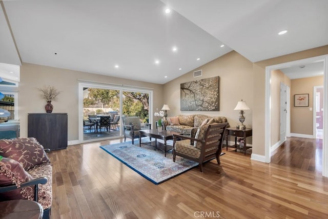 living room with lofted ceiling and light wood-type flooring