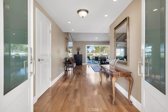 corridor with hardwood / wood-style flooring