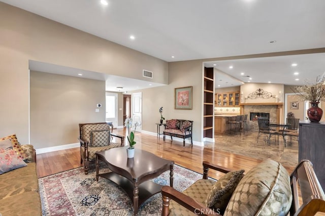 living room featuring light hardwood / wood-style flooring and a premium fireplace