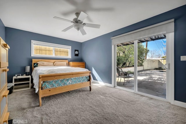 carpeted bedroom with multiple windows, access to outside, and ceiling fan