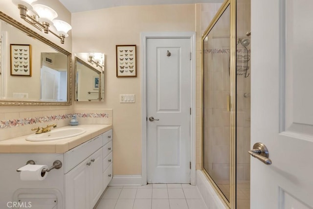 bathroom featuring vanity, shower / bath combination with glass door, and tile patterned flooring