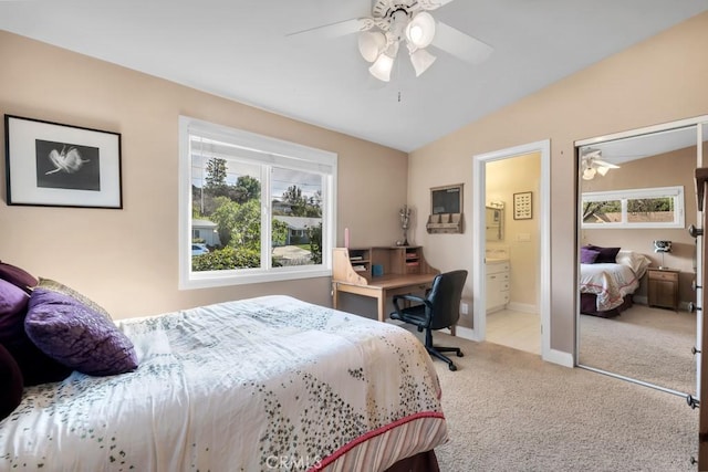 carpeted bedroom with ensuite bath, vaulted ceiling, and ceiling fan