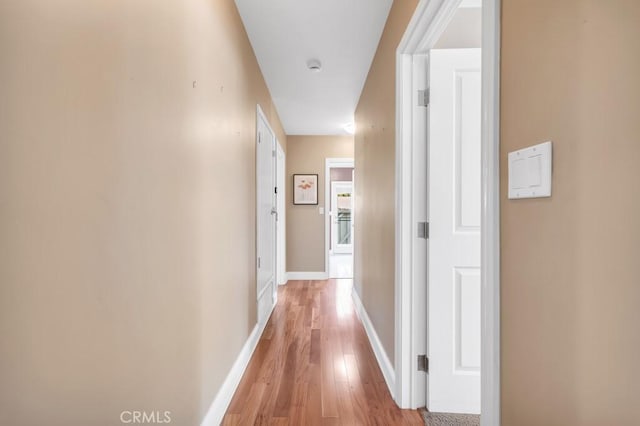 corridor with light hardwood / wood-style flooring