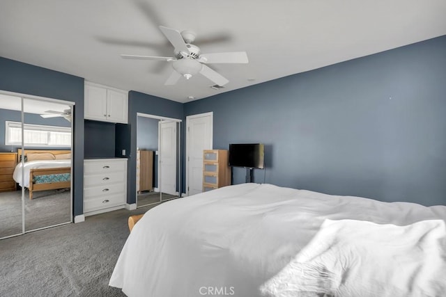 bedroom featuring dark colored carpet, two closets, and ceiling fan