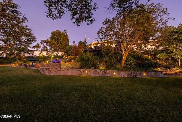 yard at dusk with a wooden deck