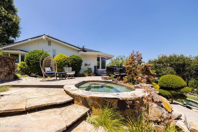 view of swimming pool with a patio and an in ground hot tub