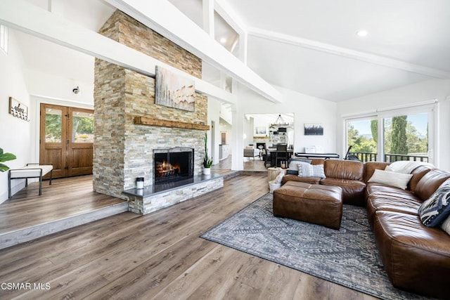 living room with hardwood / wood-style floors, a fireplace, high vaulted ceiling, and beamed ceiling