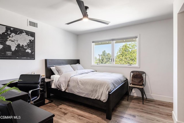 bedroom with wood-type flooring and ceiling fan