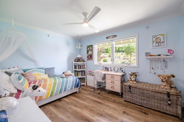 bedroom featuring hardwood / wood-style flooring, crown molding, and ceiling fan