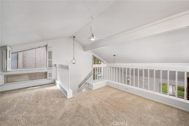 empty room featuring ceiling fan, carpet floors, and vaulted ceiling