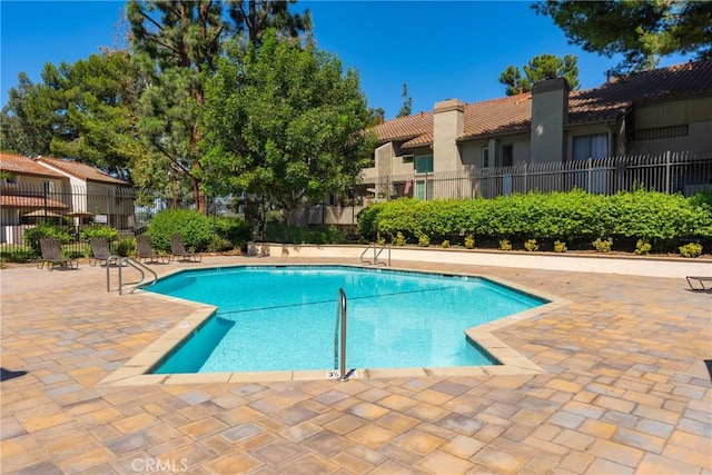 view of swimming pool with a patio area