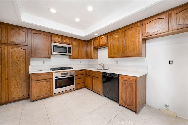 kitchen featuring light tile patterned flooring, a raised ceiling, sink, stainless steel appliances, and crown molding