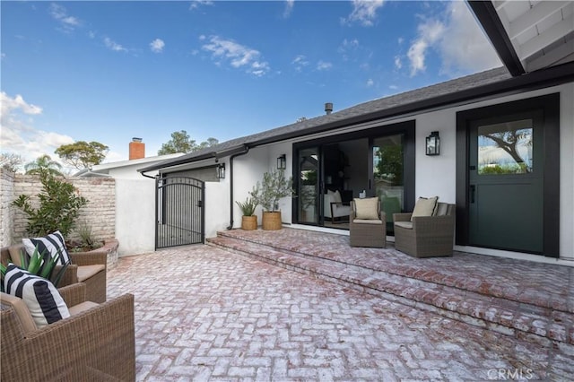 rear view of house with outdoor lounge area and a patio area