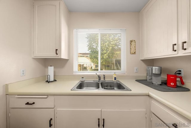 kitchen featuring sink and white cabinets