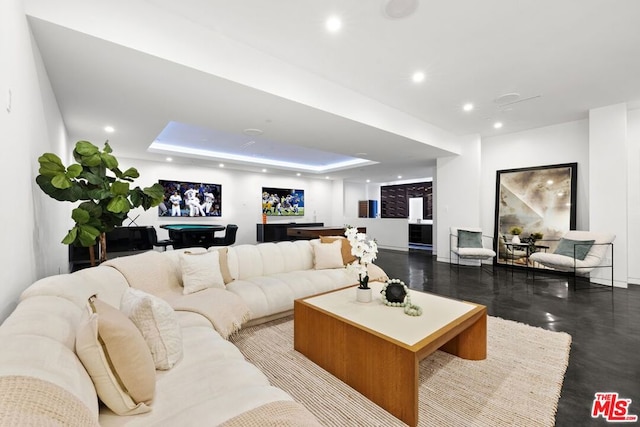 living room with billiards and a raised ceiling