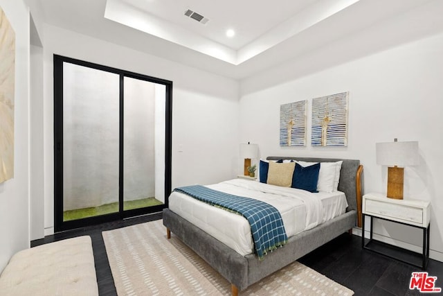 bedroom with a tray ceiling