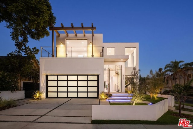 modern home with a balcony and a garage