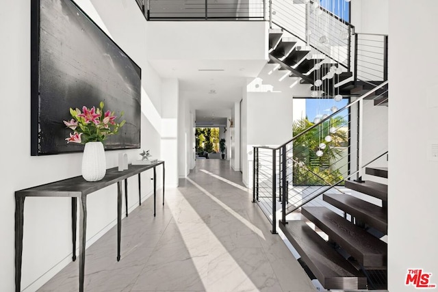 hallway featuring a towering ceiling